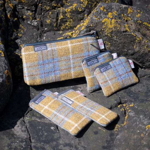  card purse shown with other items from the collection on some lichen covered rocks