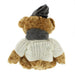 Back view of a soft brown teddy bear wearing an Arran Jumper, tweed hat and scarf.