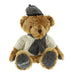 Soft brown teddy bear wearing an Arran Jumper, tweed hat and scarf. The word Scotland is embroidered on the base of the right paw. 
