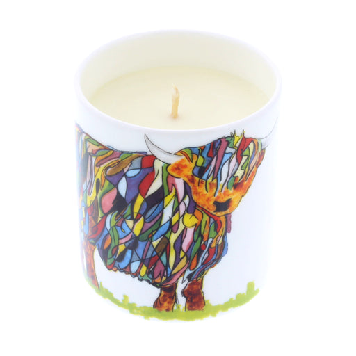 colourful highland cow candle shown in jar with wax and wick visible