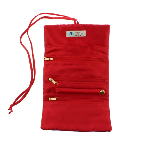 Inside of the red velvet jewellery roll showing several zipped compartments 