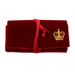 Red velvet jewellery roll embossed with a gold crown and a red ribbon to close