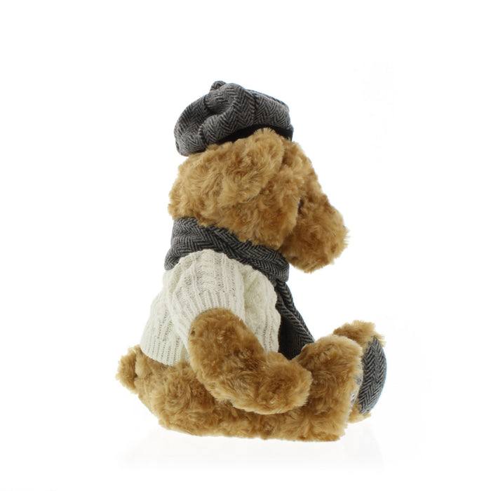 side view of teddy bear wearing hat scarf and jumper