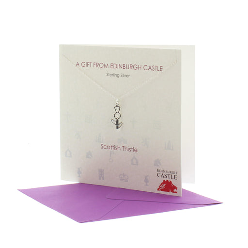 edinburgh castle thistle pendant necklace shown with presentation purple envelope and blank card to write your own message