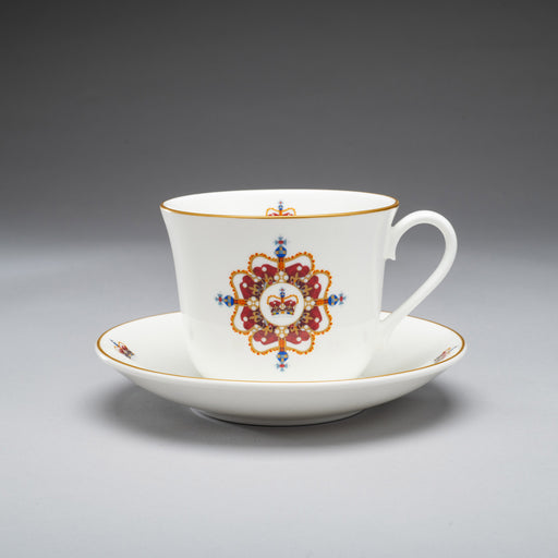Edinburgh castle crown fine bone china tea cup and saucer shown on grey background. the design has a central crown and stylized pattern