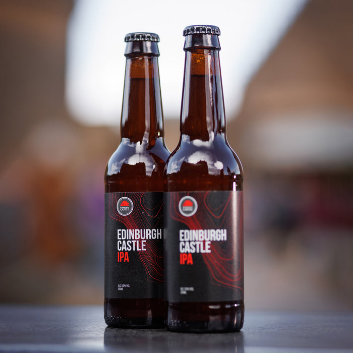 edinburgh castle IPA bottles shown sitting outside with the background in soft focus