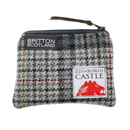 Small tweed card purse in darker grey and black colours. Branded at the top with 'Britton Scotland' and a stitched label featuring edinburgh castle and a red altered image of the castle 