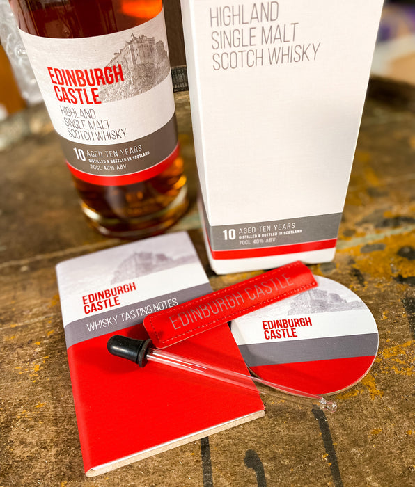 Edinburgh Castle whisky water dropper shown with other items from the collection including a notebook and coaster