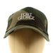 Wooden mannequin head shows a camo-print  cap with white Embroidered writing which reads Fort George, close up 