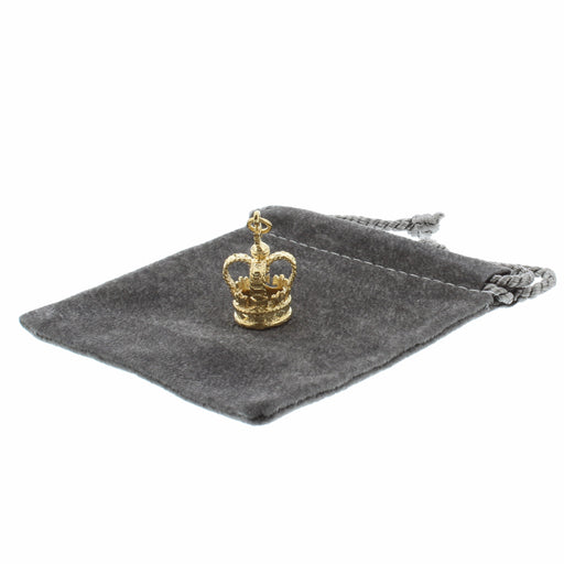 22ct Gold Plated on Brass crown shaped bracelet charm shown on grey fabric pouch