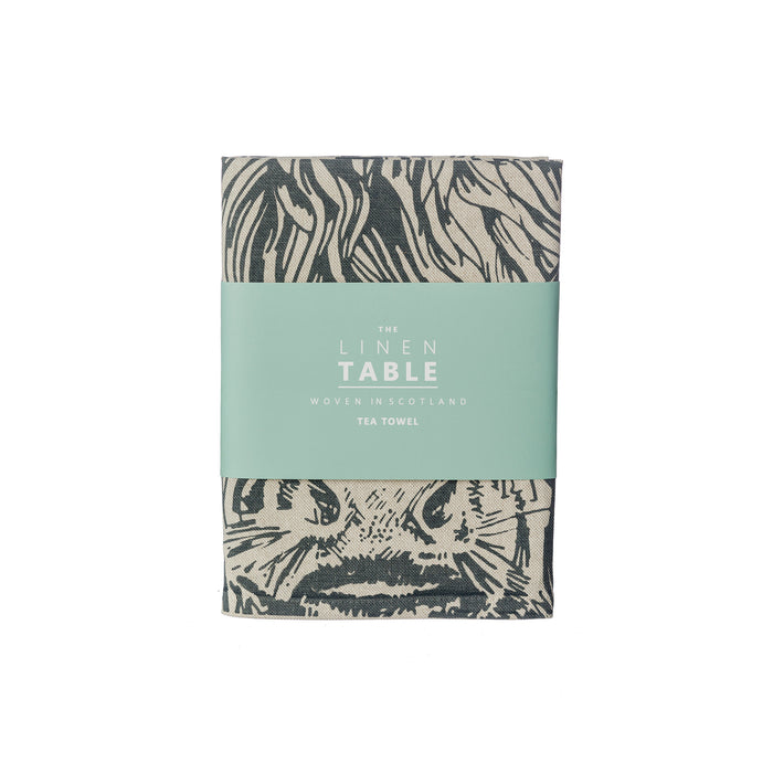 folded highland cow tea towel shown in sleeve packaging