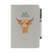 Silver soft feel note pad with a highland cow motif. the text above reads 'hello SCOTLAND' and comes with a silver pen attached.