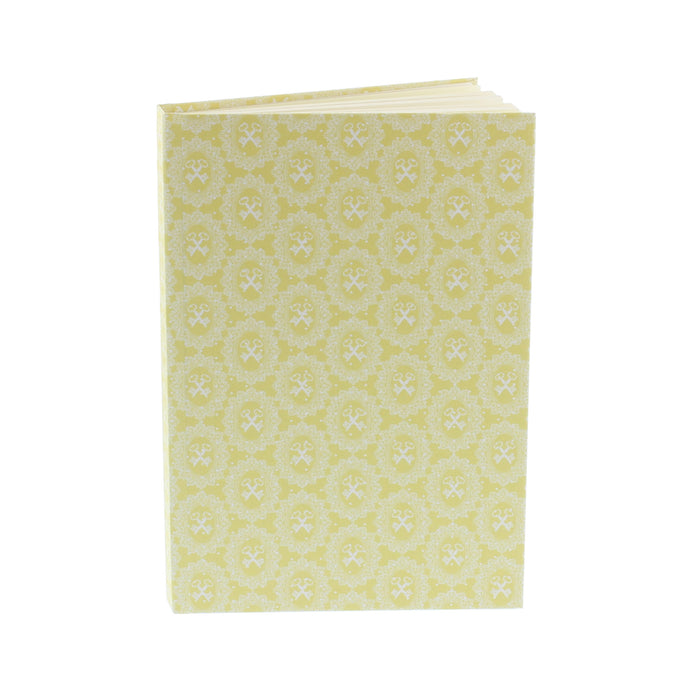 yellow hardback notebook with lace keys design in white printed on the cover in an all over pattern