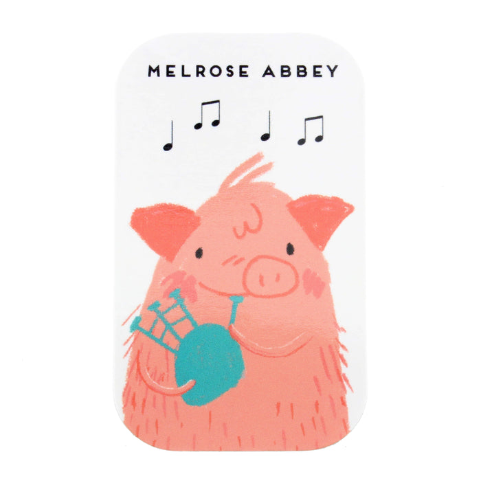 small flay magnet featuring a pink pig playing the bagpipes 