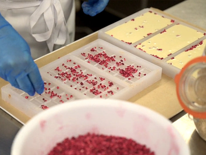 quirky historic scotland chocolate being made showing trays and white chocolate with cranberry sprinkles