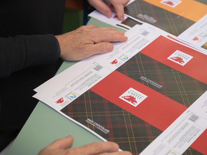 quirky chocolate edinburgh castle wrapper design proofs laid on desk