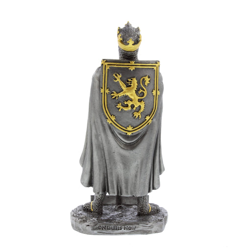The back of a pewter coloured figurine depicting Robert the Bruce holding a sword, with his Lion Rampant shield on his back. The figurien is finished with gold hand painted accents. 