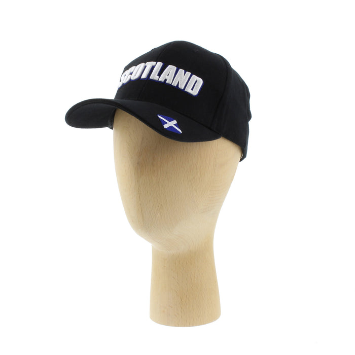 baseball cap with word scotland embroidered on front and small saltire on peak shown on wooden mannequin head