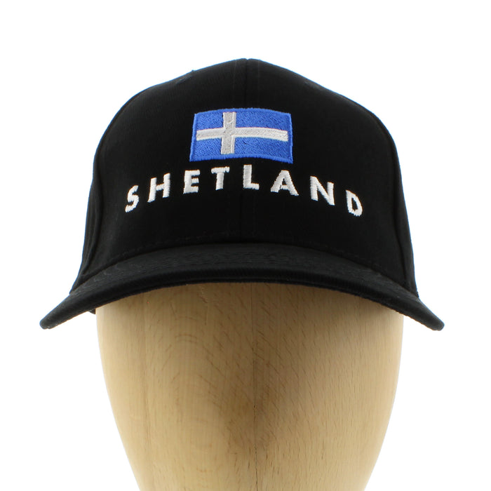 Black cap with Shetland flag and name on wooden head mannequin