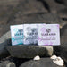 siabann soap collection shown on shore rocks with seashells in foreground