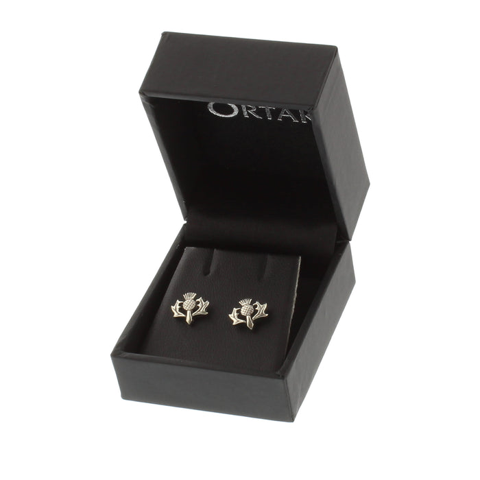silver thistle shaped stud earrings shown in open presentation box
