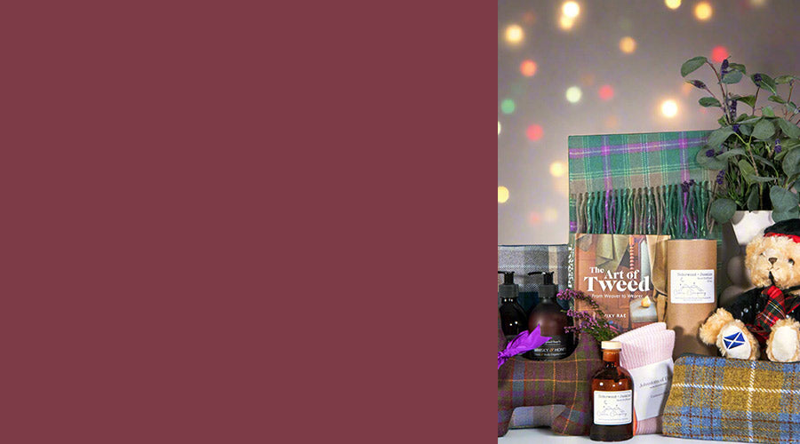 Product display with a book titled 'The Art of Tweed' and other tartan gifts on a table. - Image