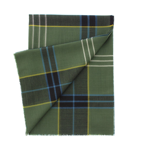 A folded green plaid scarf with fringed edges, featuring intersecting stripes of navy, light blue, yellow, and white on a solid white background. - Image