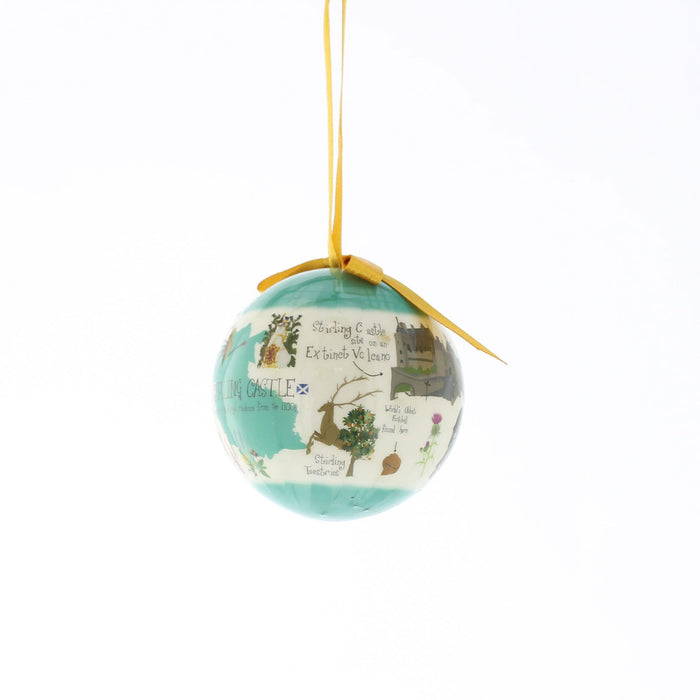 A  Christmas ornament featuring a light blue and turquoise map design with illustrations of Stirling Castle and text, hanging from a yellow ribbon on a white background. - Image