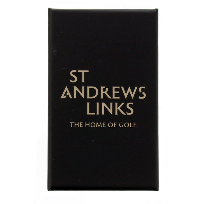 Black box with Gold text reading St Andrews Links - The home of golf - Image