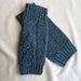 Blue knitted arm warmer in blue against a neutral background - Image