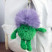 Green plush Thistle keychain attached to a white bag. - Image