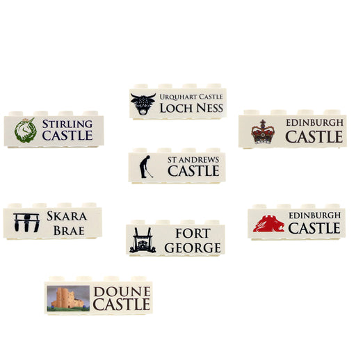 A set of seven miniature white bricks featuring different castle emblems and names, including Stirling Castle, Urquhart Castle, Edinburgh Castle, Fort George, and Doune Castle, arranged on a plain white background. - Image