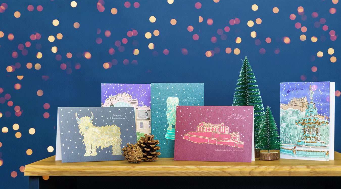 Collection of Scottish themed Christmas cards against a blue festive background.  - Image
