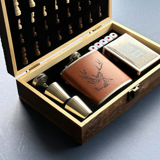 Alcohol set with leather flask, shot glasses, and playing cards in a wooden box. - Image