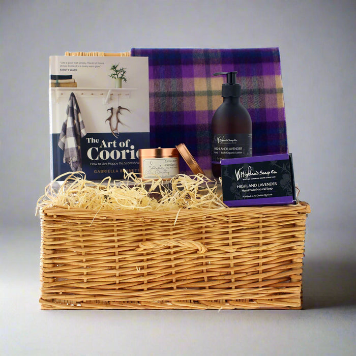 Gift basket with book, soap, and other items on a grey background - Image