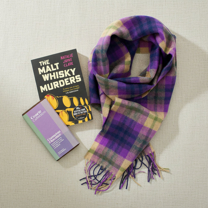 Plaid scarf and book titled 'The Malt Whisky Murders' on a white background - Image