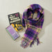 Plaid scarf and book titled 'The Malt Whisky Murders' on a white background - Image