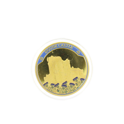 A circular gold-toned Doune Castle coin on a plain white background. - Image