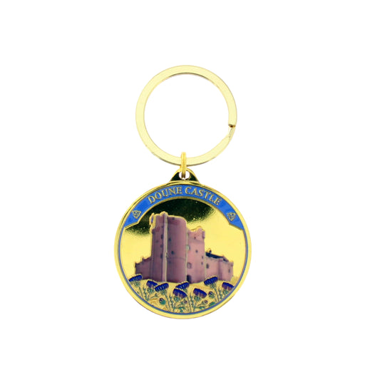 A gold-tone metal keychain featuring a circular charm with an illustration of Doune Castle, Scotland. The charm has a yellow background, a blue banner with white lettering, and purple flowers at the bottom. - Image