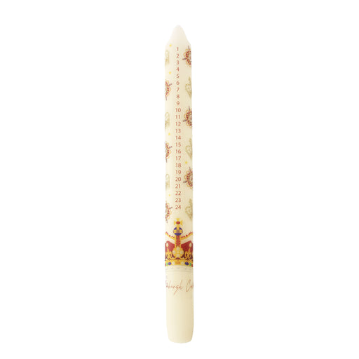 A Christmas advent candle with a cream-colored body, decorated with a printed calendar of the twelve days, small illustrations, and the Crown Jewels at the bottom. - Image