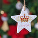 Decorative Edinburgh Castle ceramic star decoration against a Christmas Tree.  - Image
