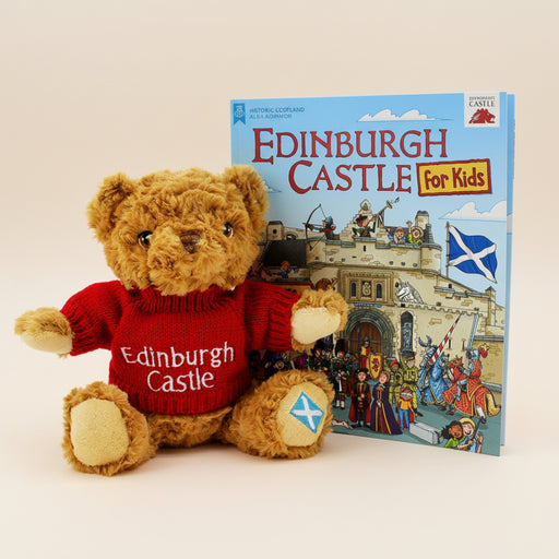 Teddy bear wearing an Edinburgh Castle sweater next to a book titled 'Edinburgh Castle for Kids' on a white background - Image