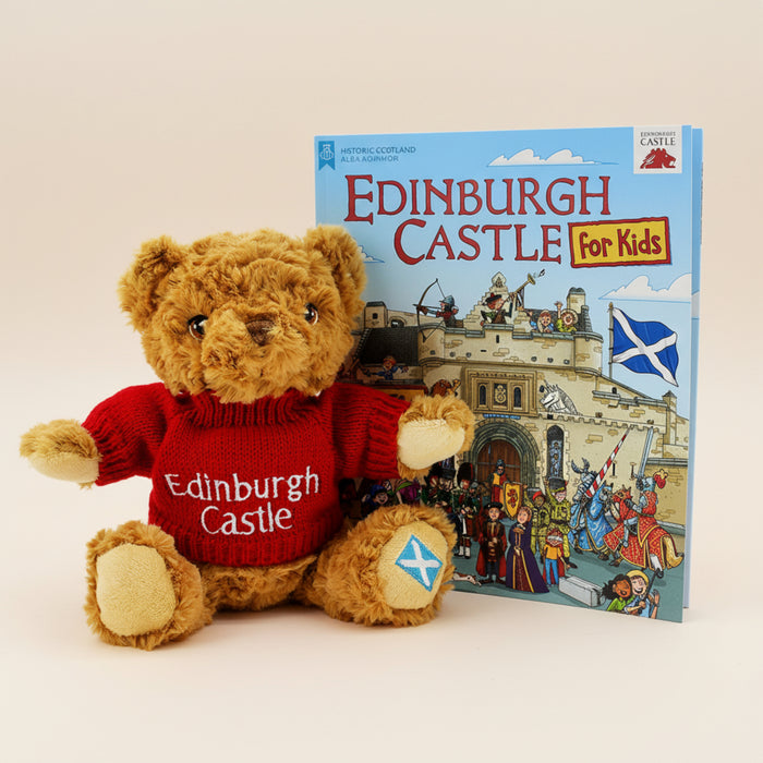 Teddy bear wearing an Edinburgh Castle sweater next to a book titled 'Edinburgh Castle for Kids' on a white background - Image