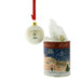 Hanging white ceramic bauble on a red ribbon with a gold text reading EDINBURGH CASTLE 2026' and it's circular tube with an artist impression of Edinburgh Castle under a snowy scape. - Image