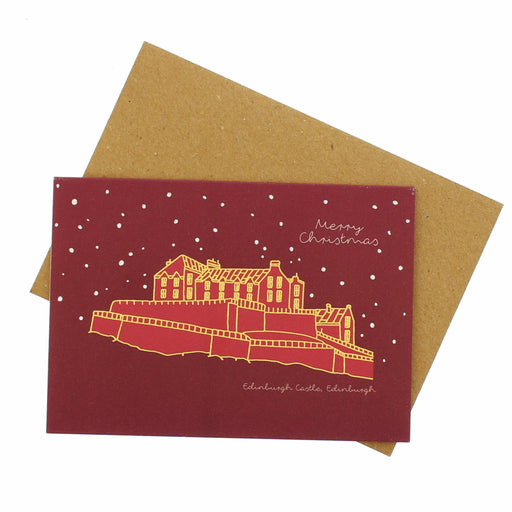 Red Christmas card with gold illustration of Edinburgh Castle and brown envelope on white background - Image