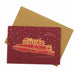 Red Christmas card with gold illustration of Edinburgh Castle and brown envelope on white background - Image