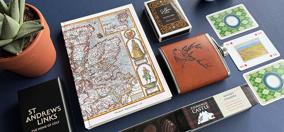 Collection of travel-themed items including a map, cards, and a leather wallet on a dark surface. - Image