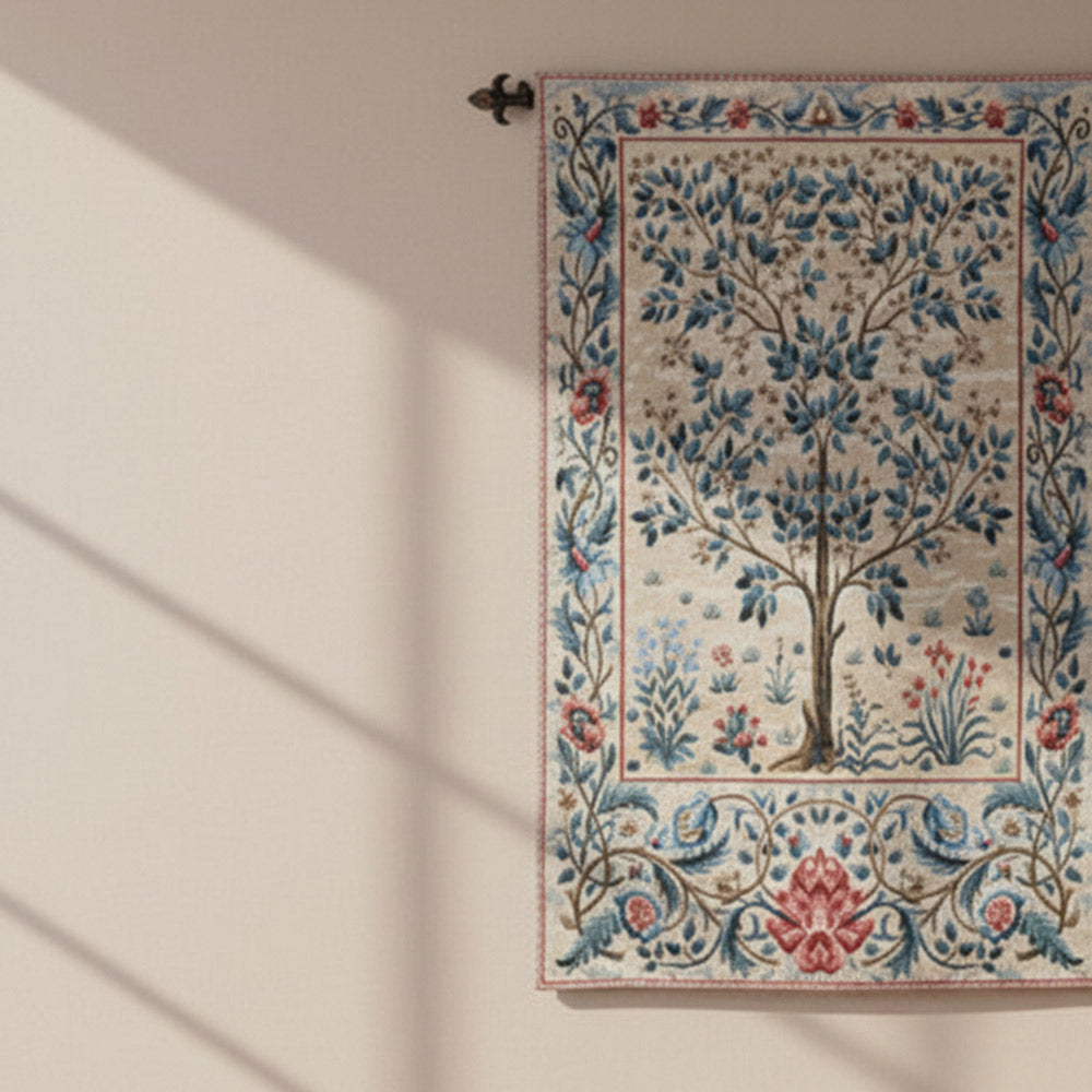 Decorative tapestry with floral and tree design hanging on a wall with plants around. - Image