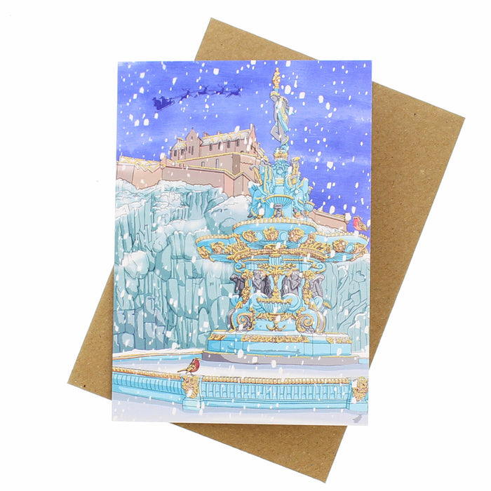 Greeting card with a winter scene of Princes St Gardens fountain and snowy landscape, featuring a brown envelope. - Image