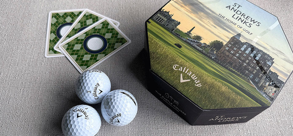 Callaway golf balls and cards with St. Andrews Links packaging on a gray surface - Image